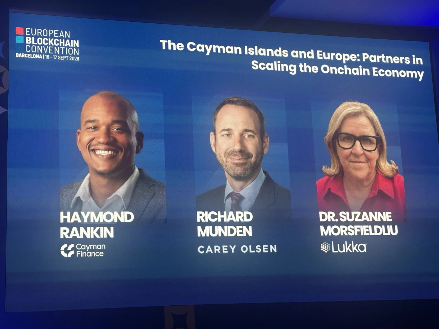 Slide del panel EBC 2026 con Haymond Rankin di Cayman Finance, Richard Munden di Carey Olsen e Suzanne Morsfield di Lukka